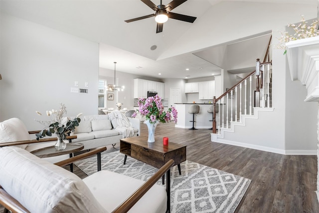 living area with baseboards, lofted ceiling, dark wood-style floors, stairs, and ceiling fan with notable chandelier