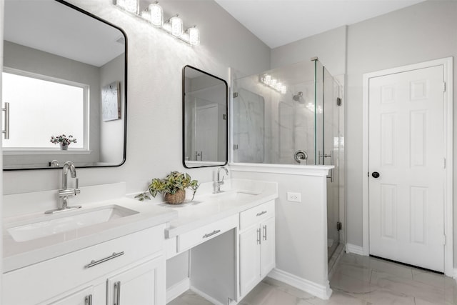 full bathroom featuring double vanity, marble finish floor, a sink, and a stall shower