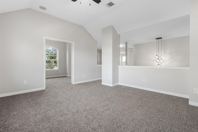 carpeted spare room featuring lofted ceiling, baseboards, visible vents, and ceiling fan