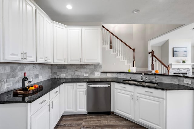 kitchen with tasteful backsplash, white cabinets, dishwasher, dark wood-style flooring, and a sink