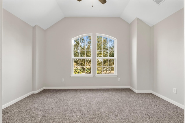 empty room featuring lofted ceiling, carpet flooring, ceiling fan, and baseboards