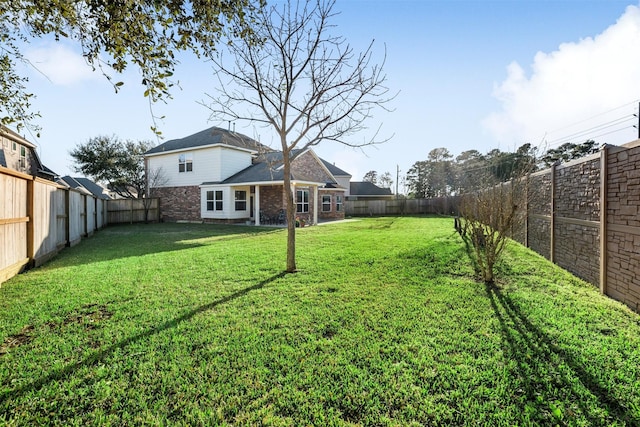 view of yard with a fenced backyard