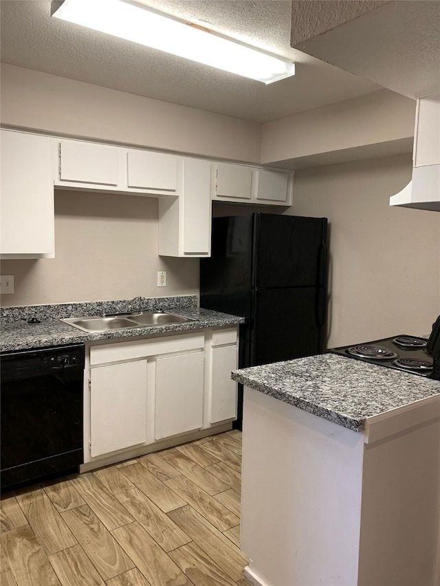 kitchen featuring a textured ceiling, a sink, white cabinetry, wood tiled floor, and black appliances