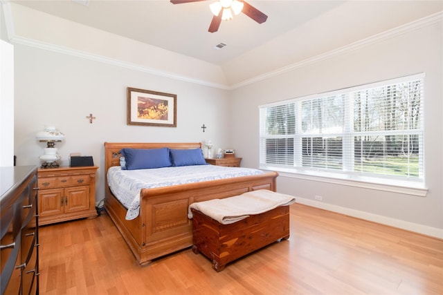 bedroom featuring ornamental molding, light wood-type flooring, lofted ceiling, and baseboards