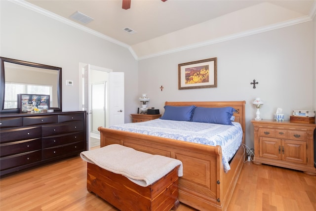 bedroom featuring visible vents, vaulted ceiling, and light wood finished floors