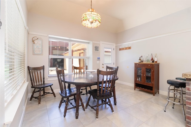 dining room with light tile patterned flooring, an inviting chandelier, and baseboards