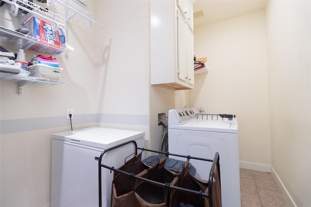 laundry room with cabinet space, light tile patterned floors, baseboards, visible vents, and washing machine and clothes dryer