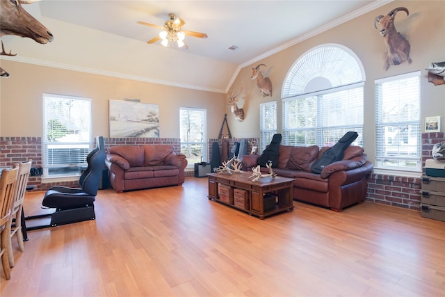 living room featuring a healthy amount of sunlight, light wood finished floors, and crown molding