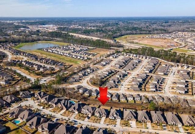 bird's eye view featuring a water view and a residential view