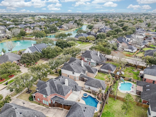 bird's eye view featuring a water view and a residential view