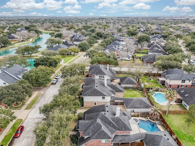 birds eye view of property featuring a water view and a residential view