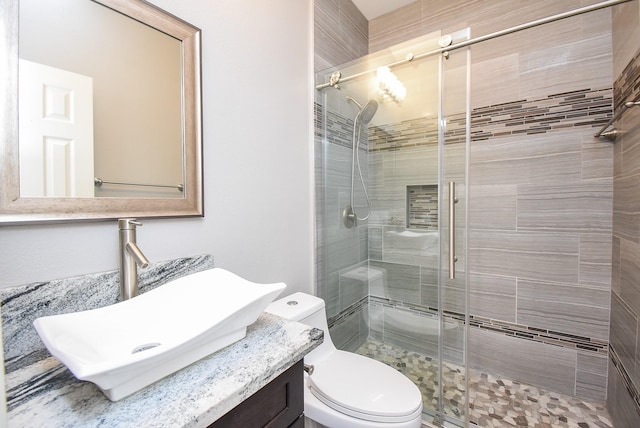 full bath featuring a shower stall, toilet, and vanity