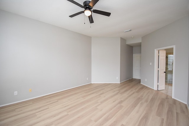 spare room with light wood-style flooring, visible vents, ceiling fan, and baseboards