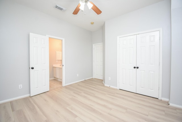 unfurnished bedroom featuring light wood finished floors, a closet, visible vents, and baseboards