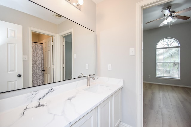 full bathroom featuring baseboards, visible vents, wood finished floors, and vanity