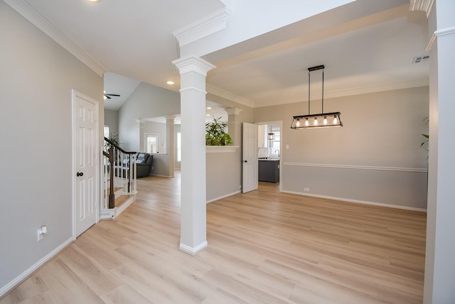 unfurnished dining area with visible vents, light wood-style flooring, ornamental molding, ornate columns, and stairs