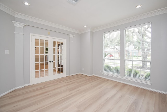 empty room featuring french doors, light wood finished floors, recessed lighting, ornamental molding, and baseboards