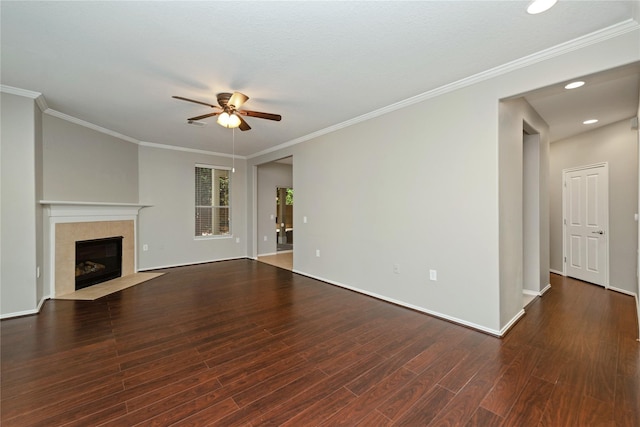 unfurnished living room with a tiled fireplace, a ceiling fan, ornamental molding, wood finished floors, and baseboards