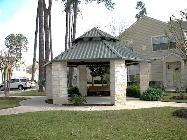 view of property's community with a yard and a gazebo