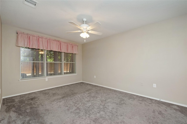 carpeted empty room featuring visible vents, ceiling fan, and baseboards