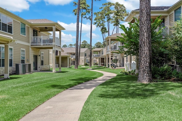 view of property's community featuring a residential view and a lawn