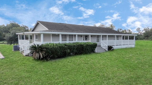 back of property featuring a porch, a sunroom, roof with shingles, and a yard