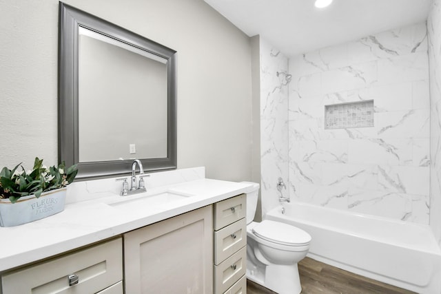 bathroom with toilet, shower / bathtub combination, wood finished floors, and vanity