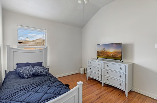 bedroom featuring vaulted ceiling, ceiling fan, light wood-type flooring, and baseboards