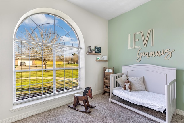 carpeted bedroom featuring baseboards