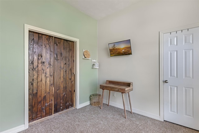 interior space with carpet and baseboards