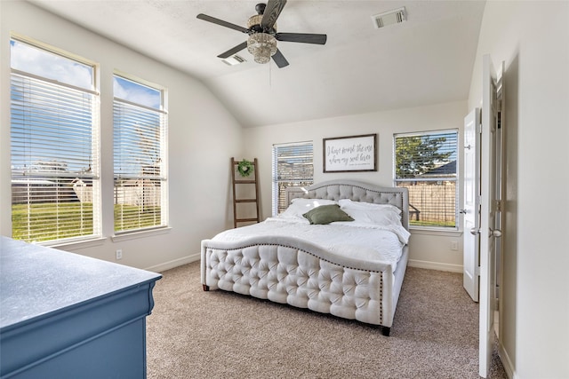 bedroom featuring lofted ceiling, light colored carpet, visible vents, and baseboards