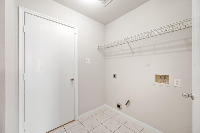 clothes washing area with hookup for a washing machine, hookup for an electric dryer, hookup for a gas dryer, laundry area, and baseboards