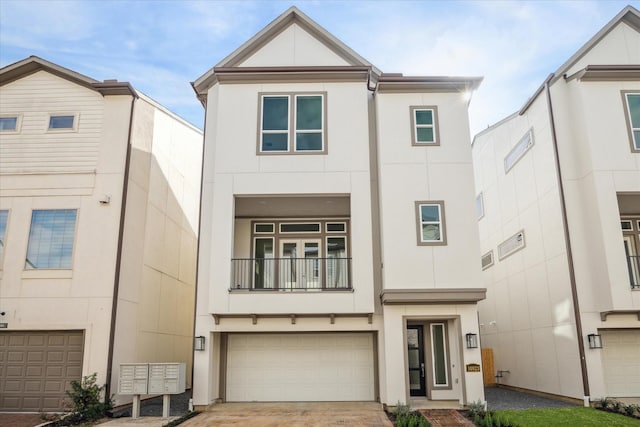 view of front facade with driveway, a balcony, an attached garage, and stucco siding