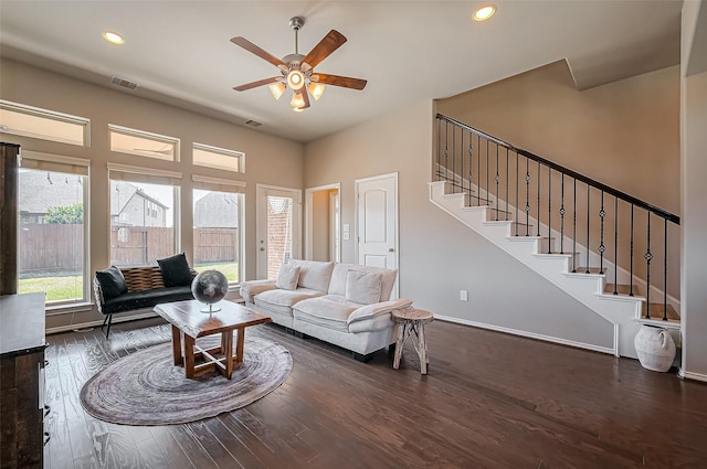 living room featuring stairs, visible vents, dark wood-type flooring, and recessed lighting