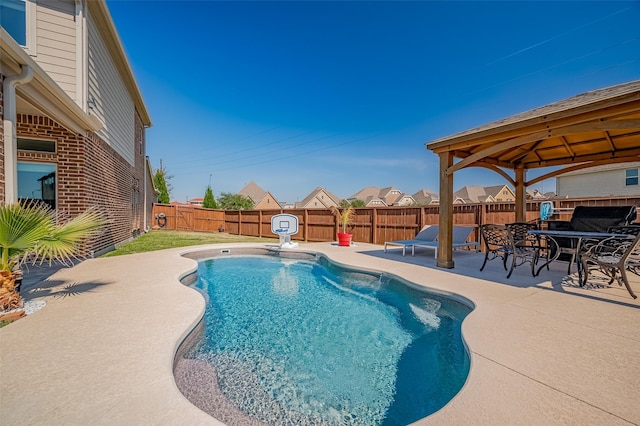 view of swimming pool with a patio, a gazebo, and a fenced backyard