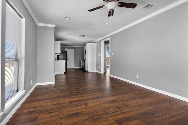 unfurnished living room with visible vents, dark wood finished floors, and baseboards