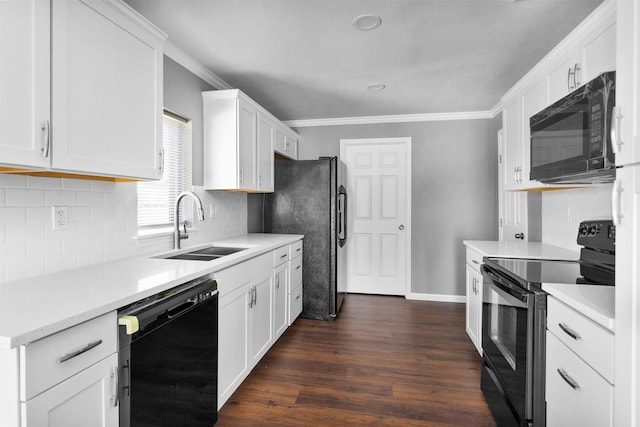 kitchen featuring crown molding, dark wood-style flooring, a sink, and black appliances