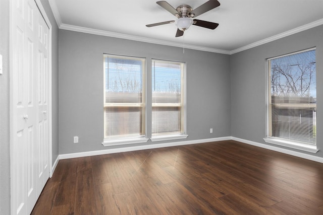 unfurnished bedroom with dark wood-type flooring, a closet, and baseboards