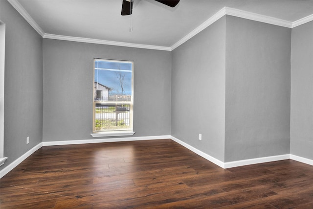 empty room featuring crown molding, baseboards, and wood finished floors