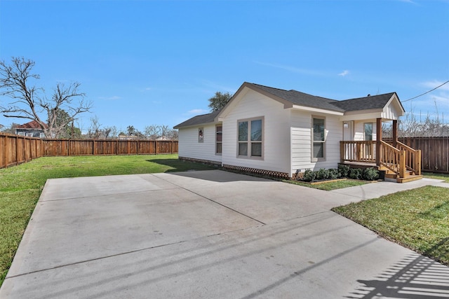 view of property exterior featuring a yard, roof with shingles, a patio area, and a fenced backyard