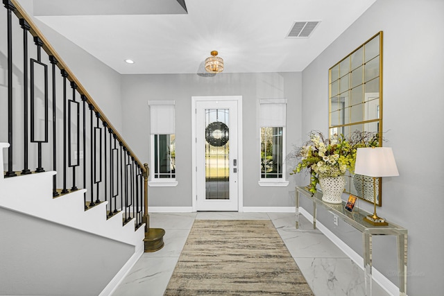 foyer featuring marble finish floor, recessed lighting, visible vents, baseboards, and stairs