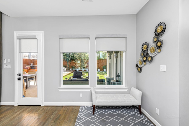 sitting room featuring wood finished floors, visible vents, and baseboards