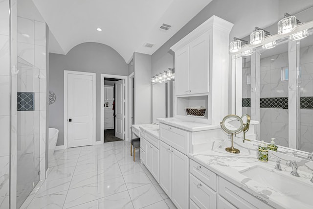 full bath featuring baseboards, lofted ceiling, marble finish floor, a tile shower, and vanity