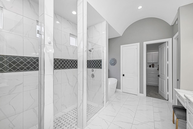 full bath with marble finish floor, lofted ceiling, recessed lighting, a tile shower, and a freestanding tub