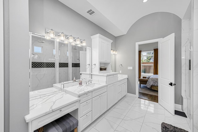 ensuite bathroom featuring visible vents, ensuite bathroom, marble finish floor, a tile shower, and vanity