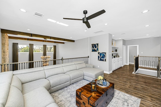 living area featuring attic access, visible vents, dark wood finished floors, and recessed lighting