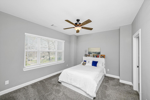 carpeted bedroom with a ceiling fan, visible vents, and baseboards