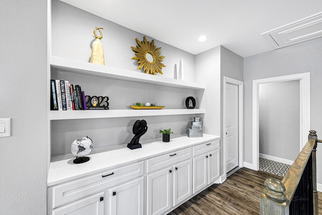 bar featuring dark wood-style floors and baseboards