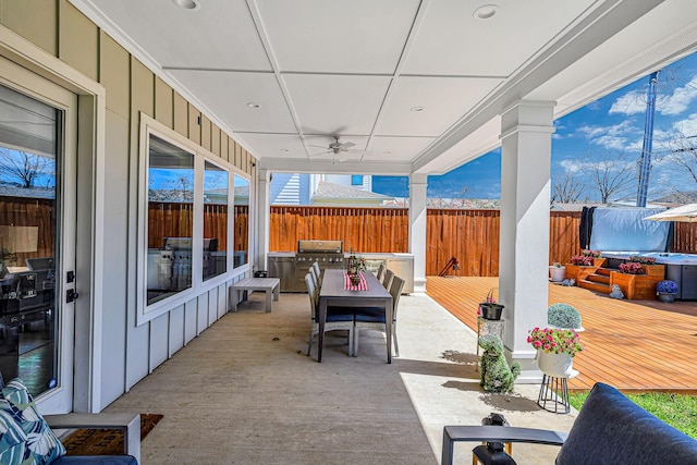 view of patio featuring a deck, ceiling fan, grilling area, and fence