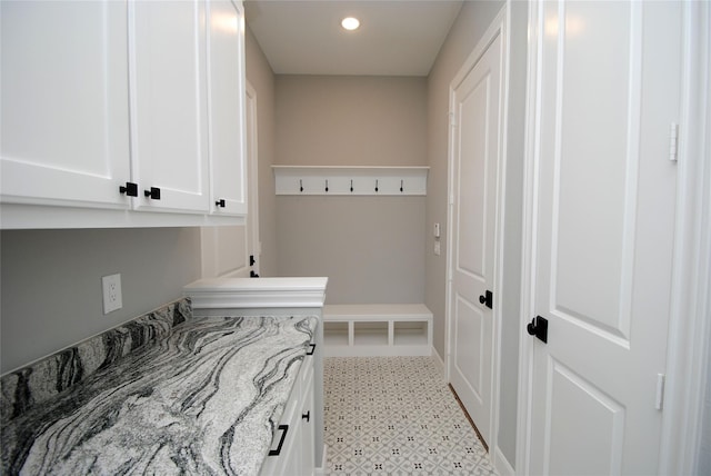 mudroom with light floors and recessed lighting